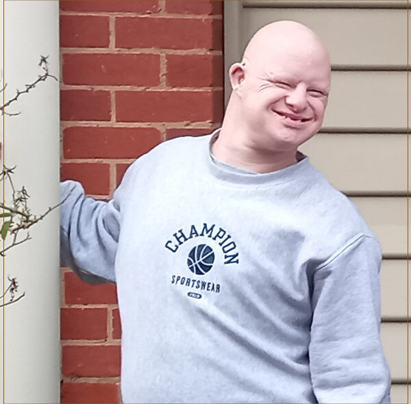 Alkira participant Julian posing in front of his new home.
