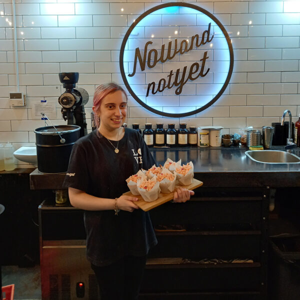 Alkira participant Johana with muffins she made at Now and Not Yet cafe.