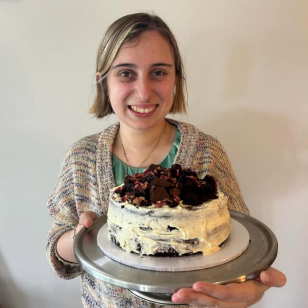 Alkira participant Johana with a cake she has baked.