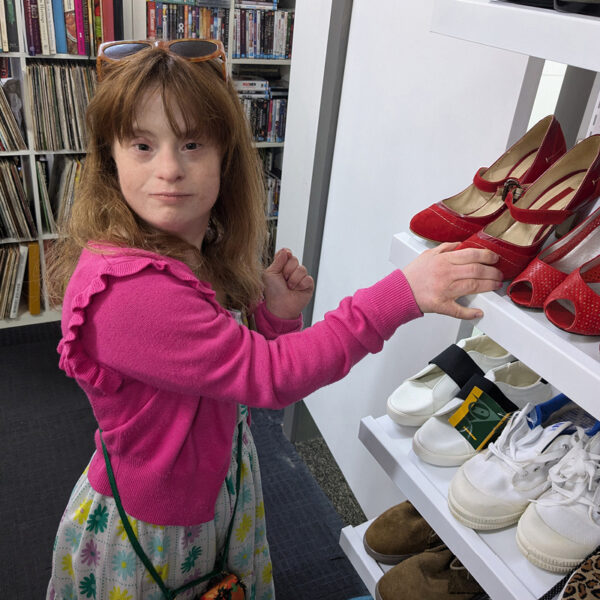 Alkira Networks participant Greer working at Vinnies arranging the shoes for display.