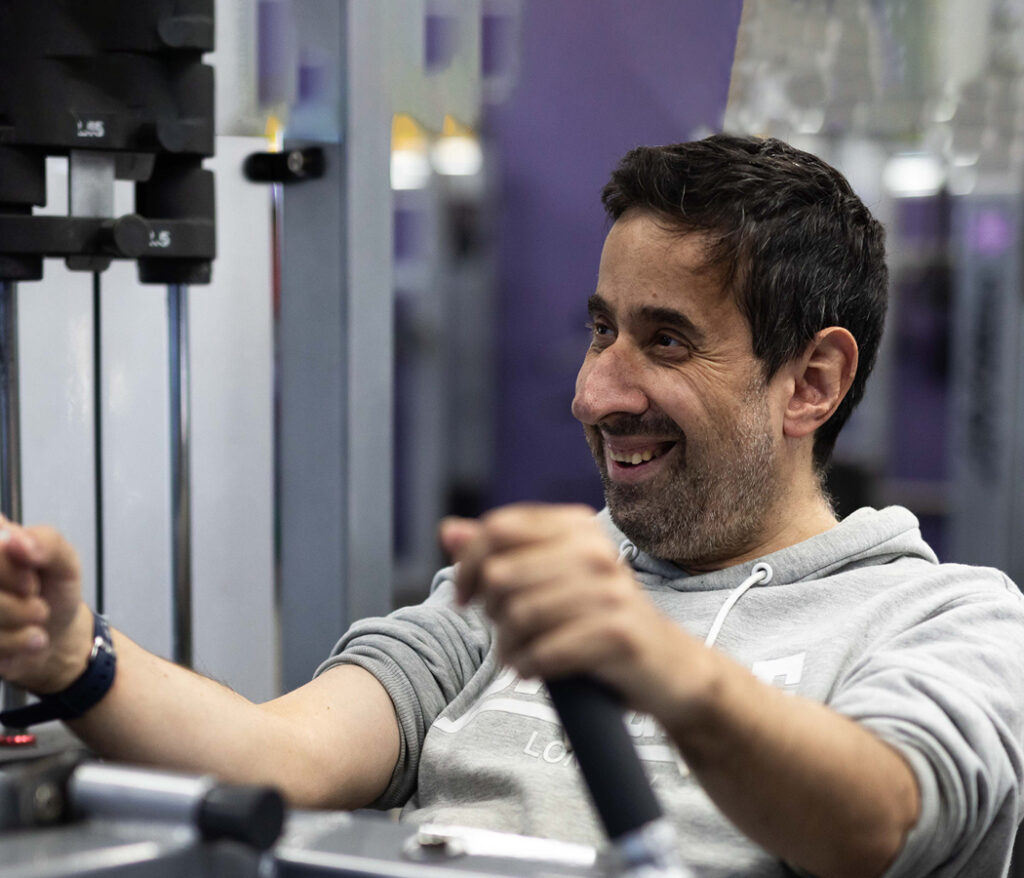 Alkira participant Frank uses a strength training machine at the gym as part of his Alkira day programs