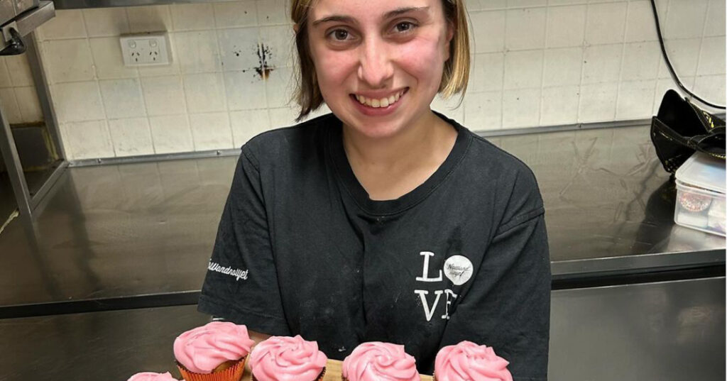 Johana shows her latest cupcakes she has baked and decorated. They have pink frosting and look delicious.