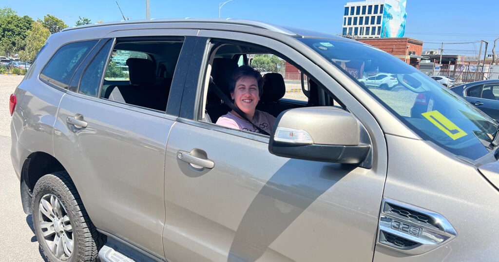 Alkira participant Megan driving her car.