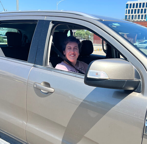 Alkira participant Megan driving her car.