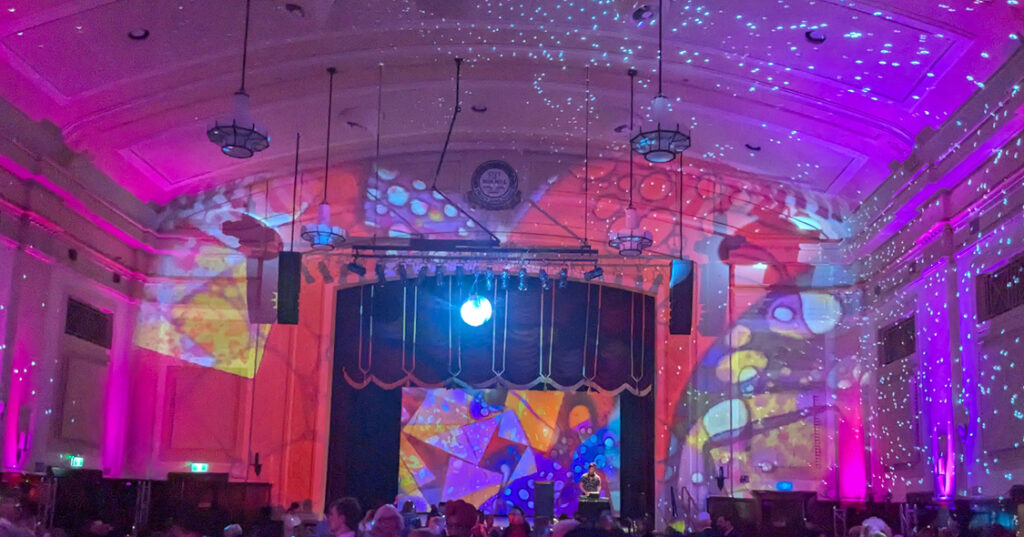 Inside of the Box Hill Town Hall with colourful lights for Alkira's 70th Anniversary Gala.