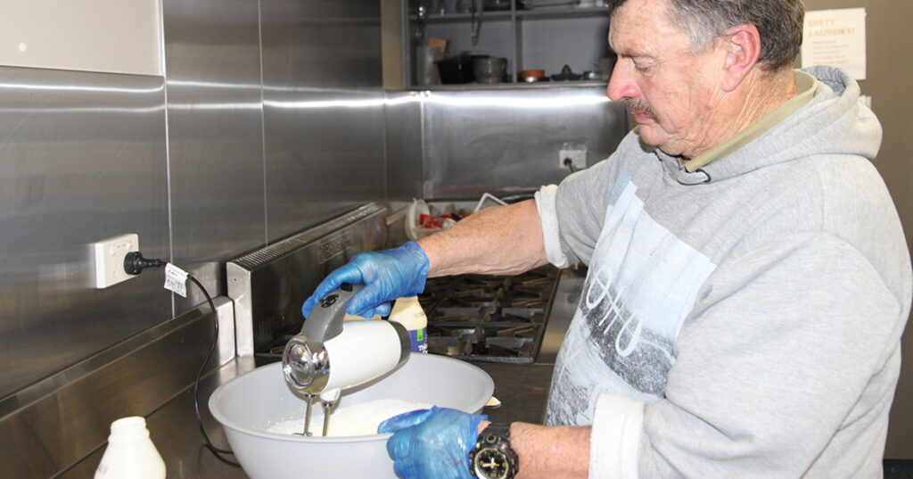 John making whipped cream as a part of the Who Wants To Be A MasterChef program.