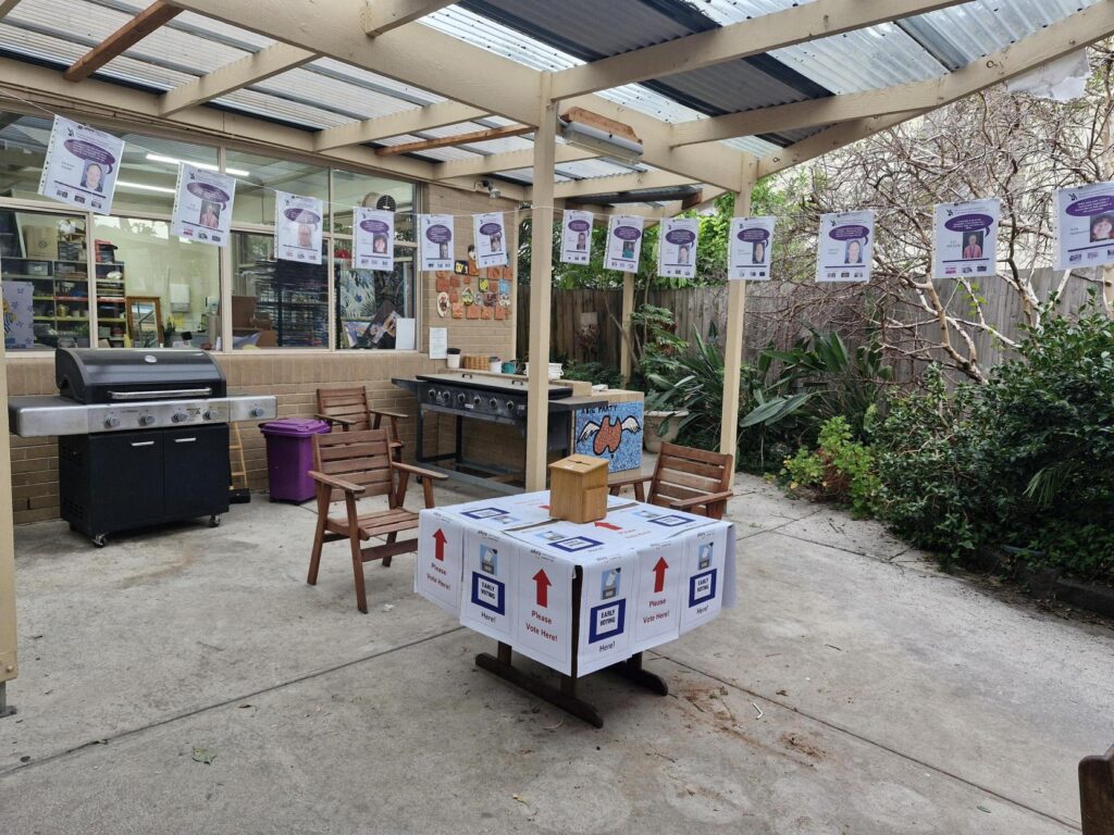 A photo of the Alkira Thurston Street Courtyard set up for voting in the election with campaign flyers and a voting box.