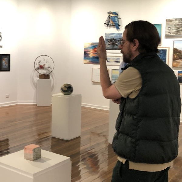 Artist Luke Kinchington visiting an art gallery as part of his alkira art programs to find inspiration.